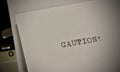 Caution text typed on old black typwriter Royalty Free Stock Photo
