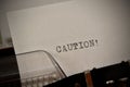 Caution text typed on old black typwriter Royalty Free Stock Photo