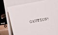 Caution text typed on old black typwriter Royalty Free Stock Photo