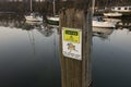 Caution trip hazard, watch your step, sign on the quayside in Caernarfon, Wales. Royalty Free Stock Photo