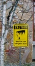 Caution. Watch for snow falling from above sign