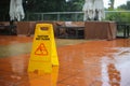 Caution wet floor yellow sign warning while it raining outside. Safety first and need to be clean. protect from injury slippery Royalty Free Stock Photo