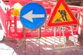 Caution work in progress sign and a large arrow to divert traffic to the construction site Royalty Free Stock Photo