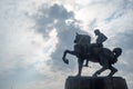 The cavalier statue on cloudy sky with sunlight background