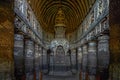 Chaitya interior showing standing Buddha figure over the stupa. Ajanta Caves,