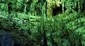 Cave dark interior with light, stalactites and stalagmites Royalty Free Stock Photo