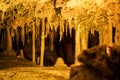Cave dark interior with light, stalactites and stalagmites Royalty Free Stock Photo