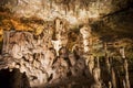 Cave dark interior with light, stalactites and stalagmites Royalty Free Stock Photo