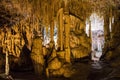 Cave dark interior with light, stalactites and stalagmites Royalty Free Stock Photo