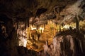 Cave dark interior with light, stalactites and stalagmites Royalty Free Stock Photo