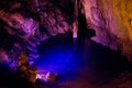 Cave Dim stone texture. The underground lake is blue inside the cave. Alanya, Turkey Royalty Free Stock Photo
