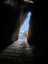 Cave entrance by ocean in vertical layout