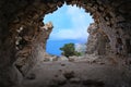 Cave entrance opening a beautiful scenery in Rhodes ,Greece, ruins, stone,Monolithos castle.island Royalty Free Stock Photo