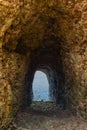 Cave with entrance to the sea. Natural tunnel in cave. Passage in rocks. Natural staircase in ocean cave.