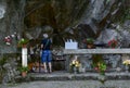Cave grotto of Lourdes with flowers and candles Royalty Free Stock Photo