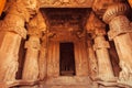 Cave hall with carved columns inside the traditional Hindu temple. Pattadakal, 7th century artworks of India.