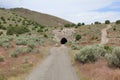 Cave in hill around sage brush Royalty Free Stock Photo