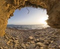 Cave hole on the beach sea sunset in Preveza Greece