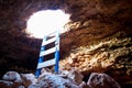 Cave hole entrance with ladder in Barbaria Cape