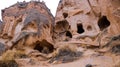 Cave houses surrounded by rock formations in Cappadocia, Turkey Royalty Free Stock Photo