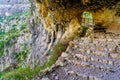 Cave in the mountain with a path with steps for hikers. Royalty Free Stock Photo