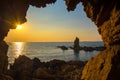 The cave near the sea on the sunset