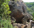 CAVE OPENINGS AND CAVERNS IN LARGE ROCK