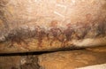 Cave paintings on the wall, painted ocher rock. prehistoric man, the primitive Neanderthal. the leader of the tribe, the shaman, p