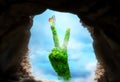 Cave portal to paradise land with peace sign tree nature hand Royalty Free Stock Photo