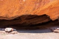 Cave in red eroded mountains. Nature scenic background. Sandstone erosion process due to wind and rains. Dzhuuku gorge Royalty Free Stock Photo