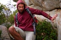 Cave, rock climbing and man hiking in mountain with backpack for adventure for wellness in trip. Earth, fitness and male Royalty Free Stock Photo