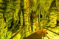 Cave rock formations are stalactites and stalagmites in colorful light. The miracle of the formation of stalagmites in
