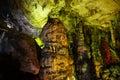 Cave rock formations are stalactites and stalagmites in colorful light. The miracle of the formation of stalagmites in the dark Royalty Free Stock Photo