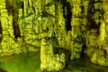 Cave rock formations are stalactites and stalagmites in colorful light. The miracle of the formation of stalagmites in the dark Royalty Free Stock Photo