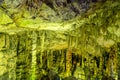 Cave rock formations are stalactites and stalagmites in colorful light. The miracle of the formation of stalagmites in the dark Royalty Free Stock Photo