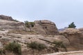 The cave in the rock near the road leading to Petra - the capital of the Nabatean kingdom in Wadi Musa city in Jordan Royalty Free Stock Photo