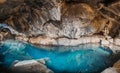 Cave Thingvellir and cavern Tingvelir in Iceland national park. Blue water and big rocks and stones inside. Royalty Free Stock Photo