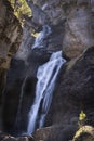 The cave waterfall in the heart of the National Park of Ordesa and Monte Perdido, set in a rocky canyon, branches and small tree Royalty Free Stock Photo