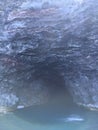 Cave and Waterfall in Napali Coast Mountains and Cliffs Seen from Pacific Ocean - Kauai Island, Hawaii. Royalty Free Stock Photo