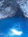 Cave and Waterfall in Napali Coast Mountains and Cliffs Seen from Pacific Ocean - Kauai Island, Hawaii. Royalty Free Stock Photo