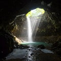 cave waterfall with sun rays - generated using ai Royalty Free Stock Photo