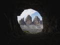 Cave window view of Tre Cime di Lavaredo alpine mountain panorama in Sexten Dolomites Belluno South Tyrol Italy alps Royalty Free Stock Photo