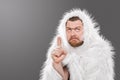 Caveman in animal skin on isolated background shows thumb up