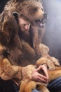 Caveman in bearskin, serious bearded man, medieval cosplay