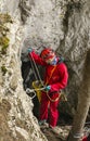 A caver preparing to enter the Czarna (Black) Cave in the Tatra Mountains, using a rope. Poland
