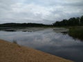 The cavernous shore of the lake under the evening overcast sky