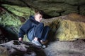 Young boy explores cave