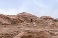 Caves in the rock near the road leading to Petra - the capital of the Nabatean kingdom in Wadi Musa city in Jordan Royalty Free Stock Photo