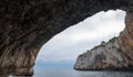 Caves of Zinzulusa, near Castro on the Salento Peninsula in Puglia, Italy. Person in silhouette stands on the gang plank