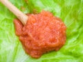 Caviar of whitefish in wood spoon on green lettuce